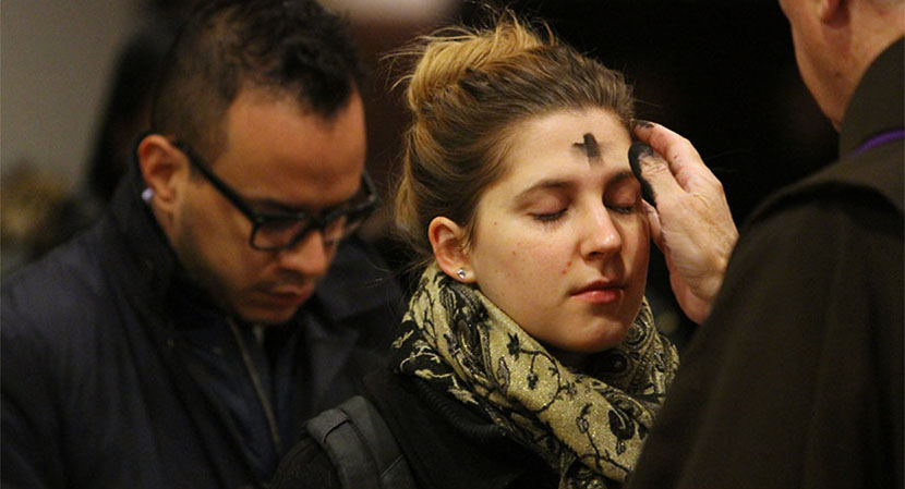 Woman receives ashes on Ash Wednesday at St. Francis of Assisi Church in New York